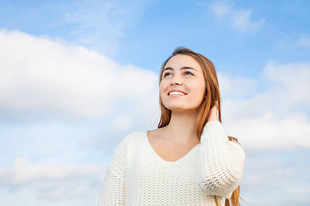 Low angle portrait of a businesswoman looking away outdoors in a sunny day