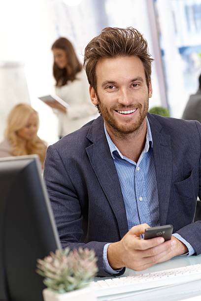 istock Handsome young businessman with mobilephone 186283385