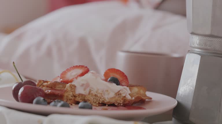 Close Up of Woman eating Valentines Day Breakfast in Bed