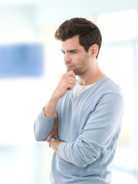 istock Smiling young man standing against white background 186284620
