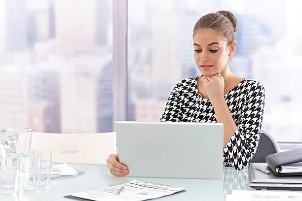 istock Young businesswoman with laptop computer 186284875