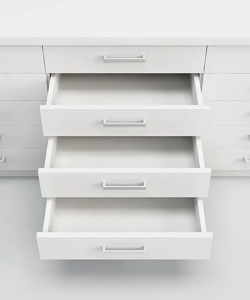 white cupboard with opened empty drawers