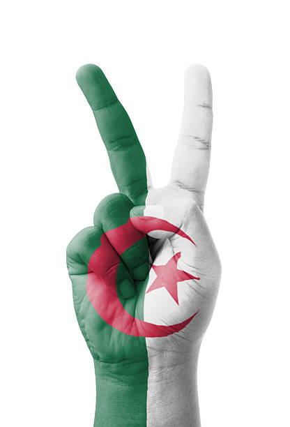 Hand making the V sign, Algeria flag painted as symbol of victory, win, success - isolated on white background