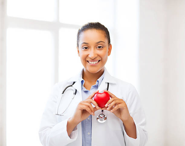 african doctor with heart stock photo