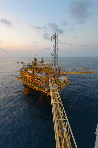 Oil and gas platform in sunset or sunrise time stock photo