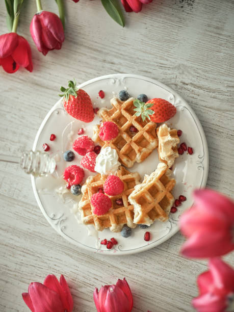 istock Sweet waffles on table with tulips 1862861626
