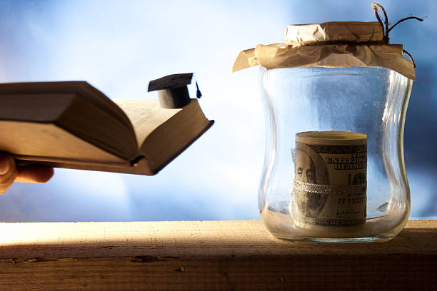 istock Small graduation cap, money and open book. 186286313