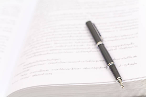 istock Close-up of open book and pen 186286492
