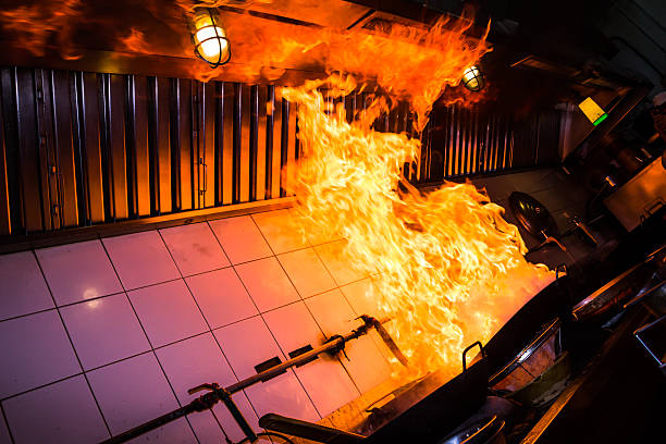 Kitchen pan fire with flames leaping to ceiling Fire gas burn is cooking on iron pan,stir fire very hot kitchen on fire stock pictures, royalty-free photos & images