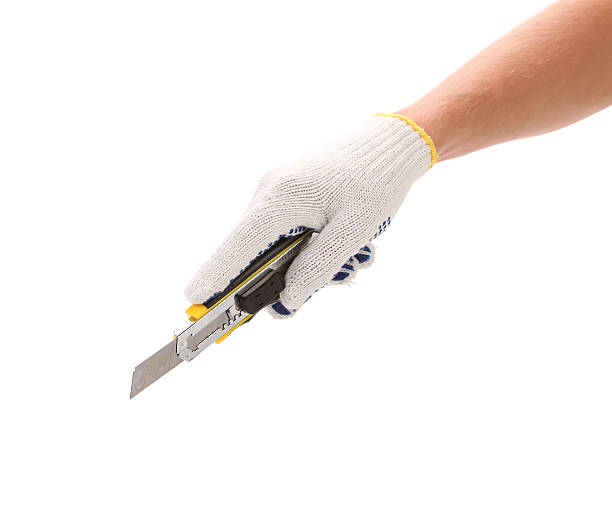 istock Hand in gloves holding knife. 186288697