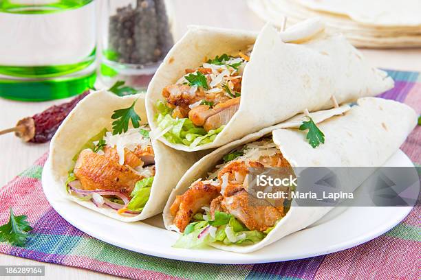 Closeup Of 3 Fish Tacos On White Plate With Colorful Napkin Stock Photo - Download Image Now