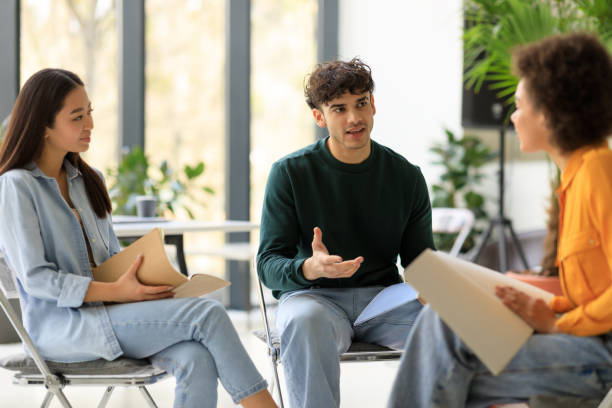 istock Group of students research. Three diverse friends planning or discussing ideas, communicating in university 1862898771
