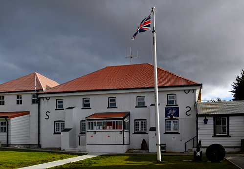 Stanley, East Falkland, Falkland Islands: Royal Falkland Islands Police Headquarters on Ross Road, flying the Union Jack (the annex on the left houses HM Prison Stanley). The Royal Falkland Islands Police (RFIP) is the territorial police force responsible for law enforcement within the Falkland Islands.