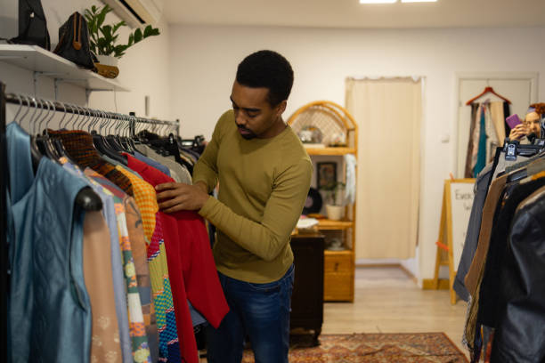 istock Young Adults Shop For Clothes at Thrift Store 1862923889