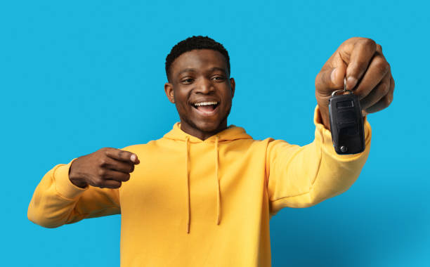 istock Happy excited black man pointing at key from new car 1862930416