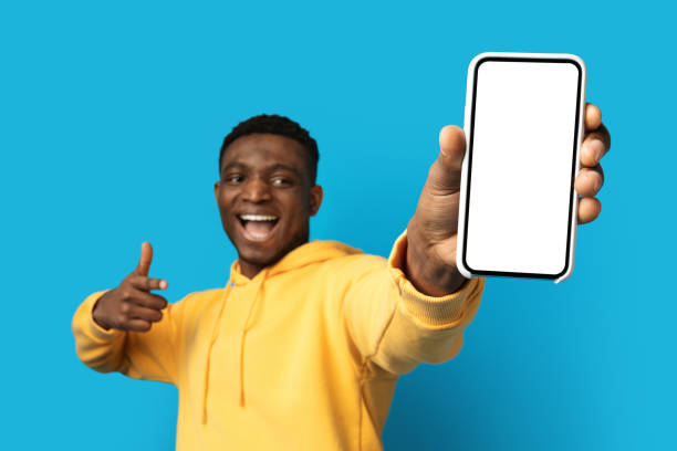 istock Cool african american guy showing smartphone with empty screen 1862930468