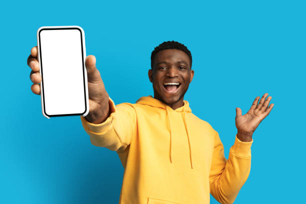 istock Excited young black guy showing big phone with blank screen 1862930691