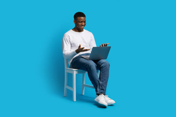 istock Black guy sitting on chair, have video call on laptop 1862930717