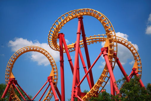 A Colorful Looping Roller Coaster On A Beautiful Sunny Day