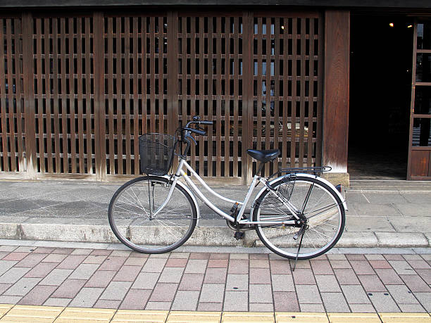istock Bicycle parking on footpath, near wooden wall. 186293603