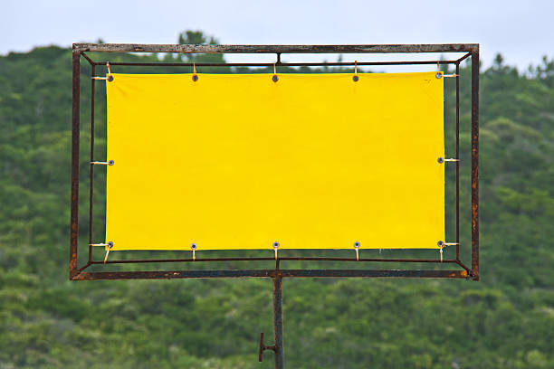 Yellow rusty sign Yellow rusty sign with wood on the background. eyelet stock pictures, royalty-free photos & images