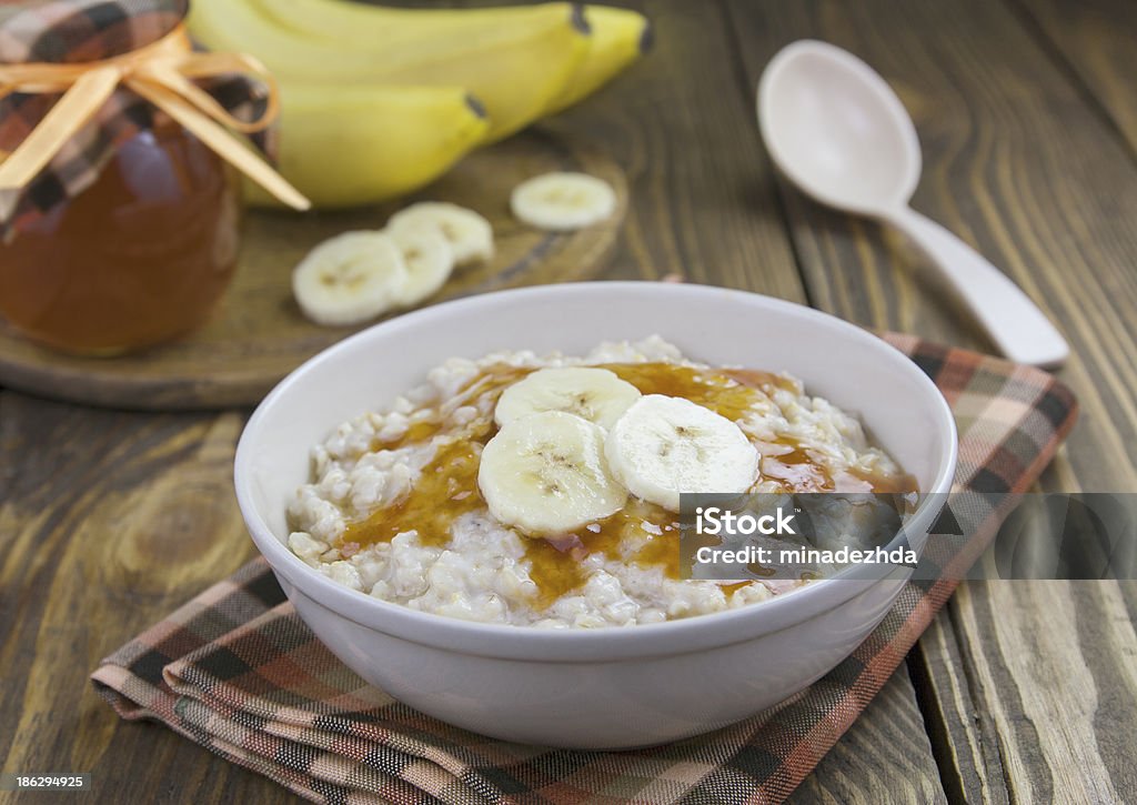 Oatmeal with bananas Porridge with bananas and syrup in a  bowl on the table Banana Stock Photo