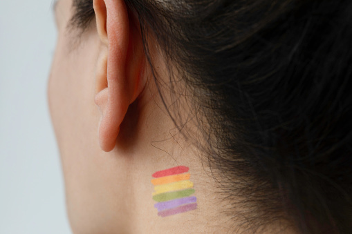 Rainbow flag on neck. 
Representing LGBT movement .