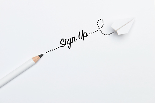 Black pencil with Sign Up text and a white paper plane on white background.