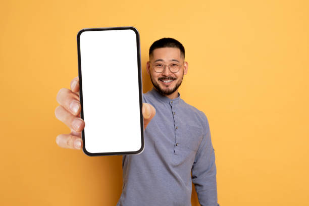 istock Handsome Asian Man Demonstrating Big Blank Smartphone In His Hand 1862957751