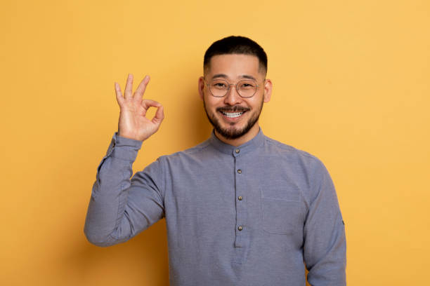 istock Happy Young Asian Man Showing Ok Gesture At Camera 1862958287