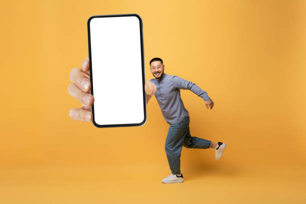 istock Funny Asian Man Running With Huge Blank Smartphone In Hand 1862958293