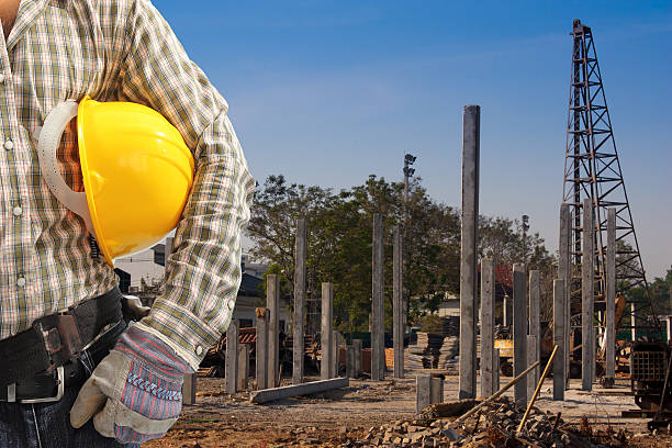 istock Pile driver  works to set precast concrete piles 186298646