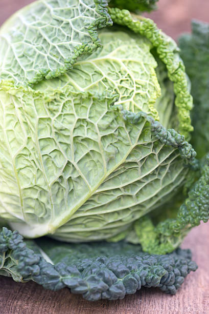 istock Fresh Savoy Cabbage on wooden background 186298713