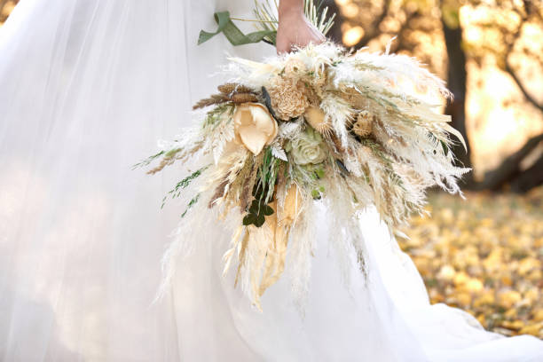 istock hands of the bride holding beautiful bouquet 1862990241