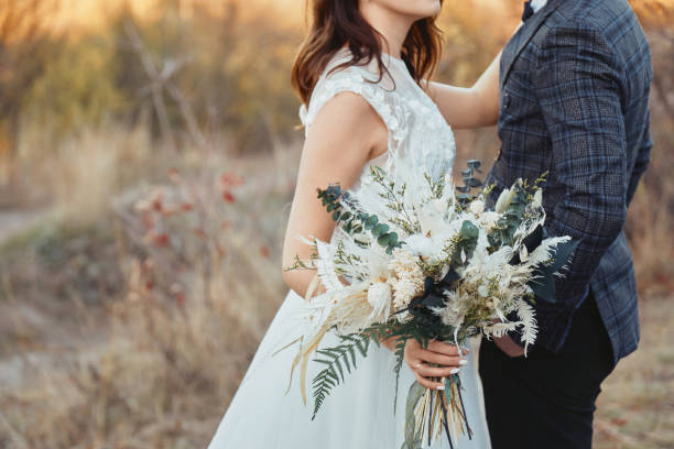 istock bride and groom holding a beautiful bouquet 1862990270
