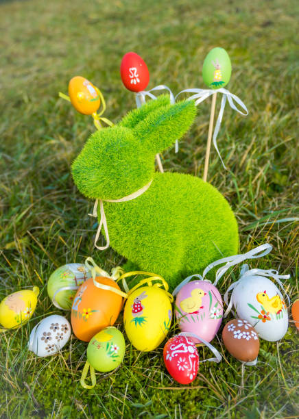 istock Small baby rabbit and easter eggs in the fresh, green spring landscape. 1863004498