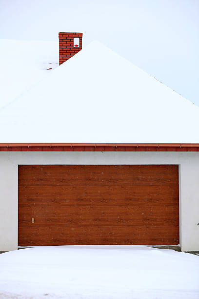 istock car garage door surrounded by snow 186301732