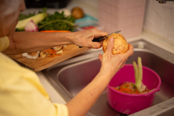 Sorting vegetable and fruit peels for fertilizer in the soil and putting them in the refrigerator in containers to reduce food waste