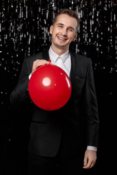 istock caucasian man in black jacket with red air balloon 1863017501