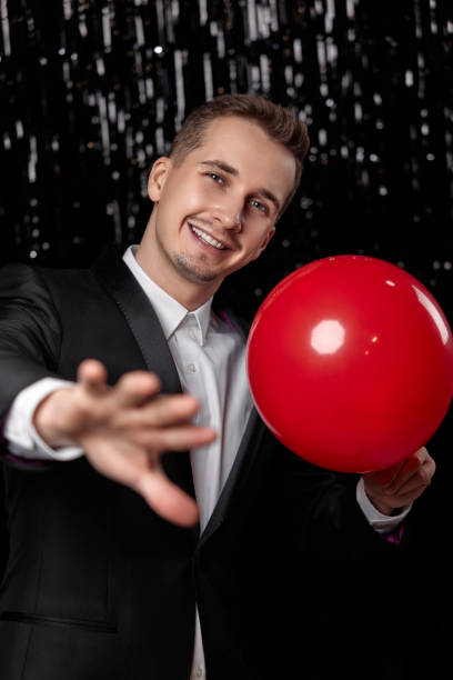 istock caucasian man in black jacket with red air balloon 1863017503