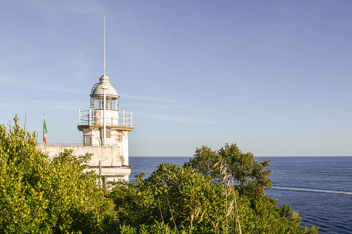 Portofino, Genoa, Liguria, Italy - 08 28 2023: Portofino Lighthouse is an active beacon, completely automated and powered by a solar unit.