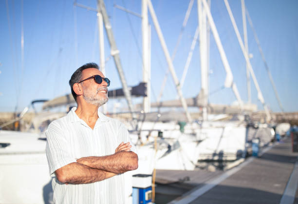 istock Relaxed Mature Man On Vacation Posing Near Yachts Outside 1863037541
