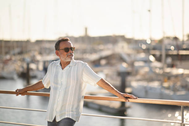 istock Senior Man Posing Among Yachts Enjoying Holidays Standing At Pier 1863038594