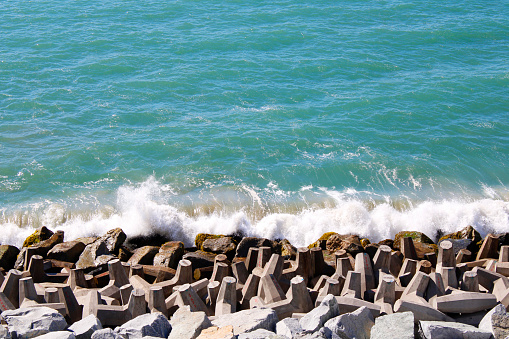 Waves breaking over rocks on the coastal edge