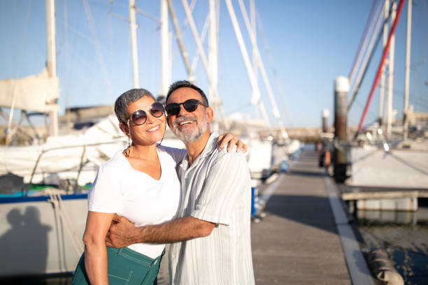 istock Cheerful Mature Spouses Embracing Posing At Marina With Yachts Outside 1863039193