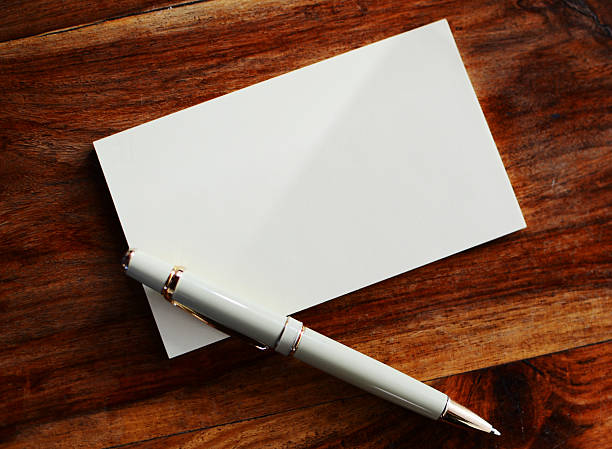 istock Blank page with pen on wooden table 186304974