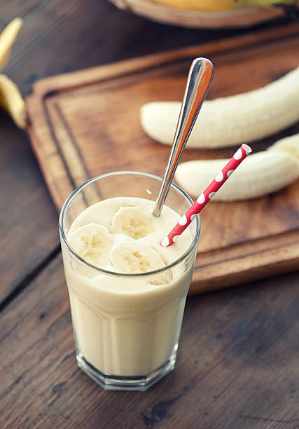 istock A banana milkshake with a red and white striped straw 186305001