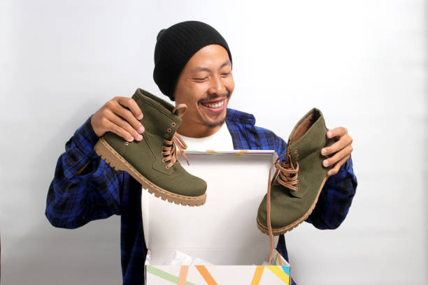 istock Asian man holding new shoes 1863071750