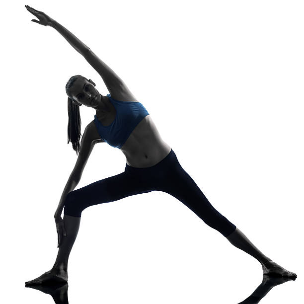 istock woman exercising stretching triangle pose yoga 186307471
