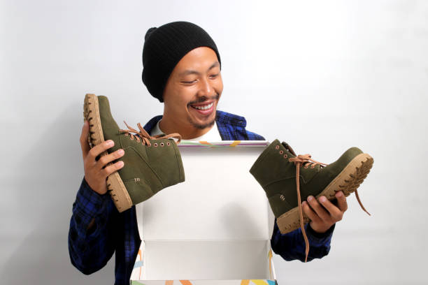 istock Asian man holding new shoes 1863077916